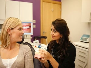 dr sunita verma with a dental patient